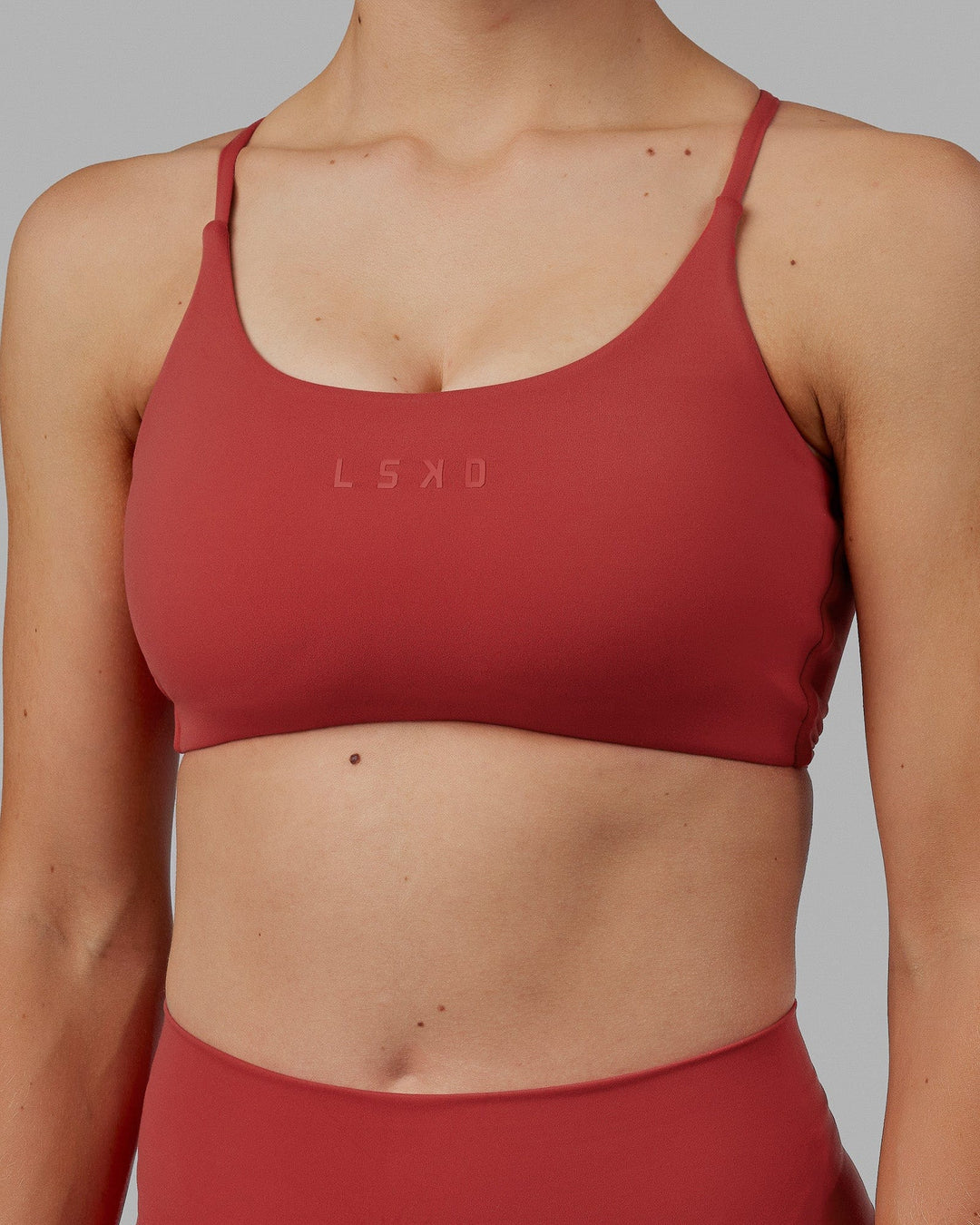 Woman wearing Twist Sports Bra - Cardinal