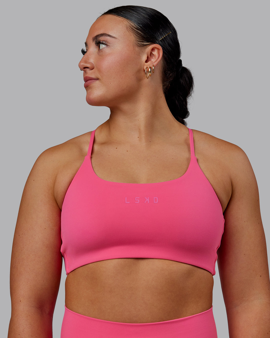 Woman wearing Twist Sports Bra - Carmine Rose
