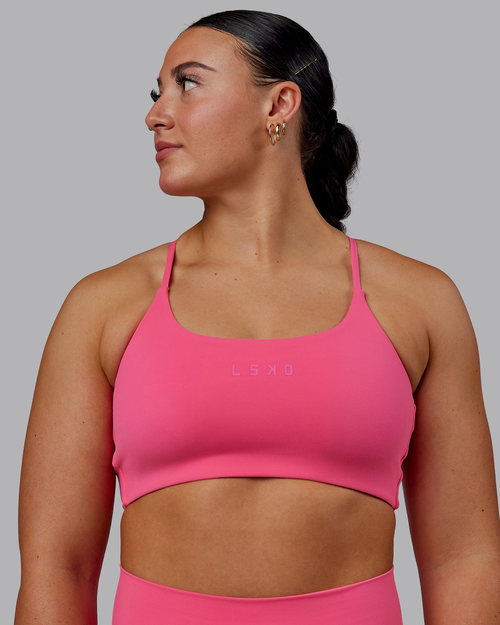 Woman wearing Twist Sports Bra - Carmine Rose