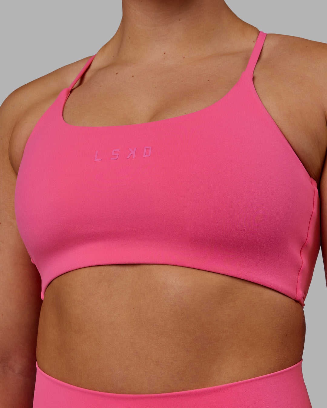 Woman wearing Twist Sports Bra - Carmine Rose