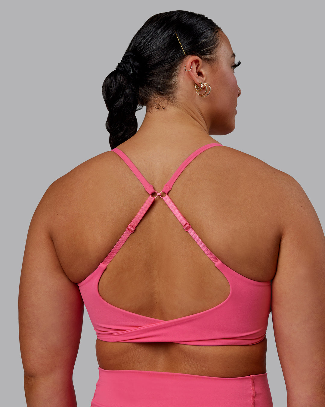 Woman wearing Twist Sports Bra - Carmine Rose