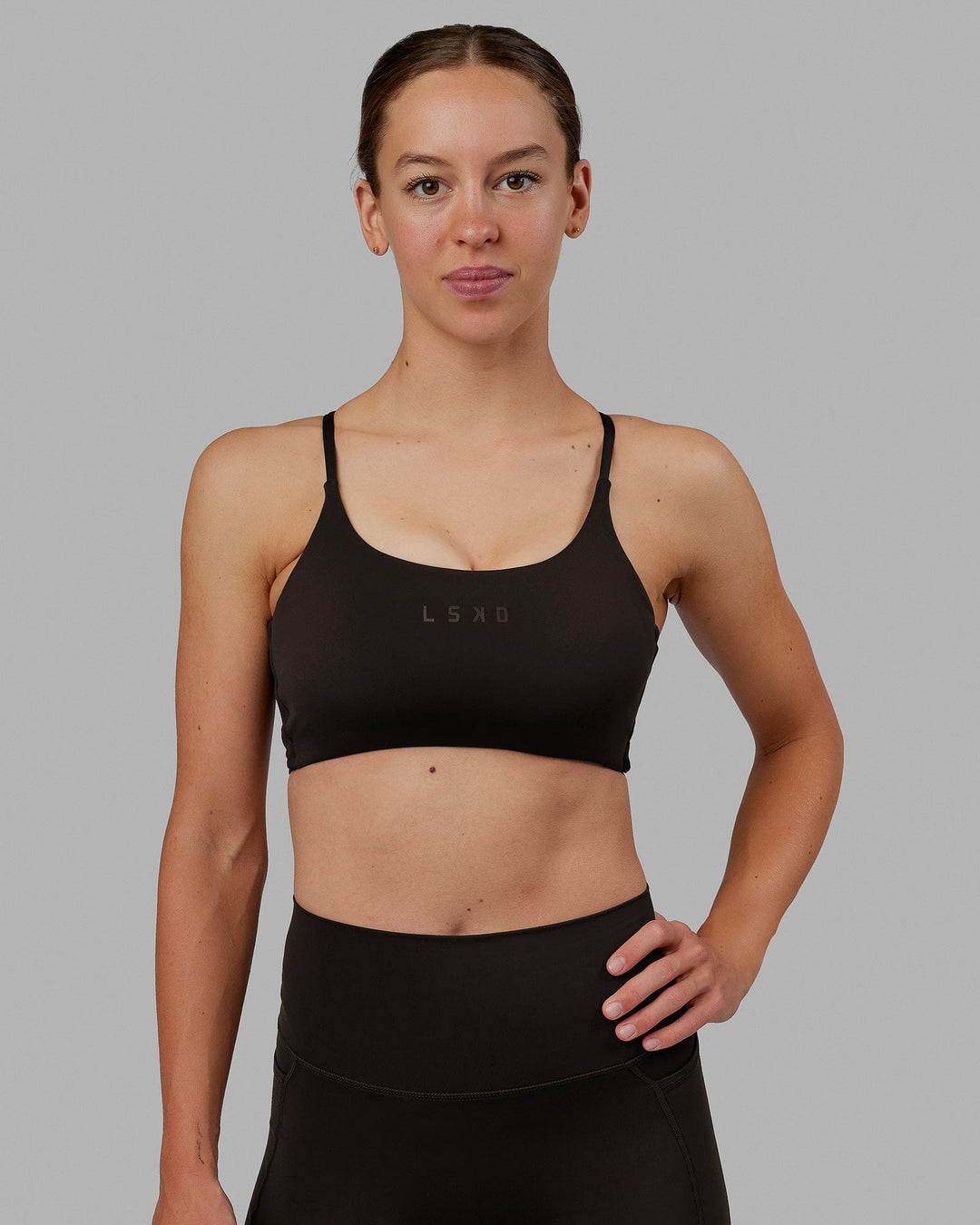 Woman wearing Twist Sports Bra - Dark Walnut