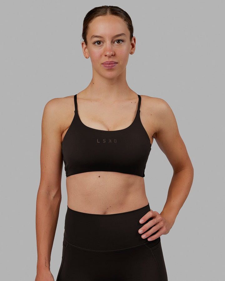 Woman wearing Twist Sports Bra - Dark Walnut