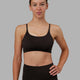Woman wearing Twist Sports Bra - Dark Walnut