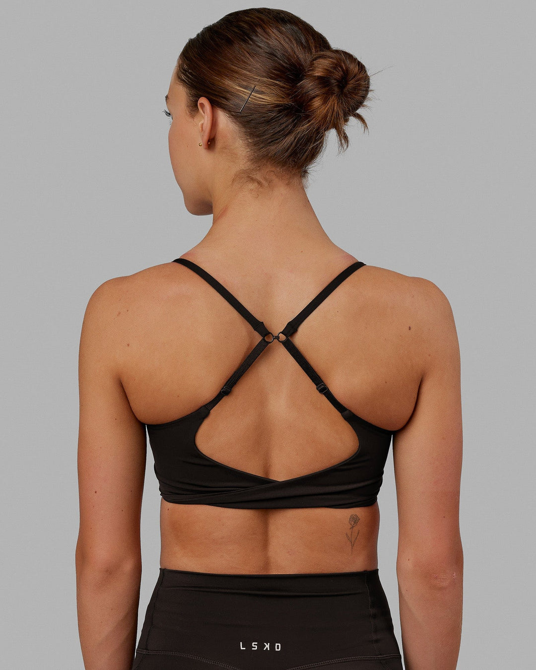 Woman wearing Twist Sports Bra - Dark Walnut