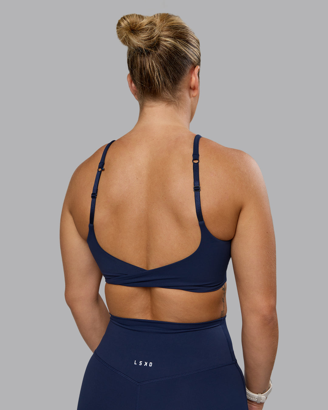Woman wearing Twist Sports Bra - Future Navy | Model:Lyss | Size:S