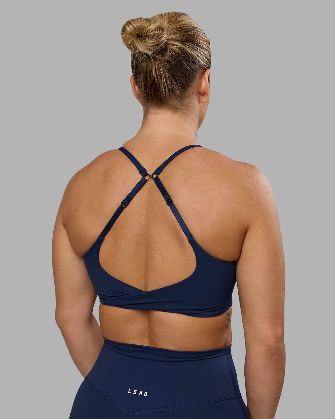 Woman wearing Twist Sports Bra - Future Navy | Model:Lyss | Size:S