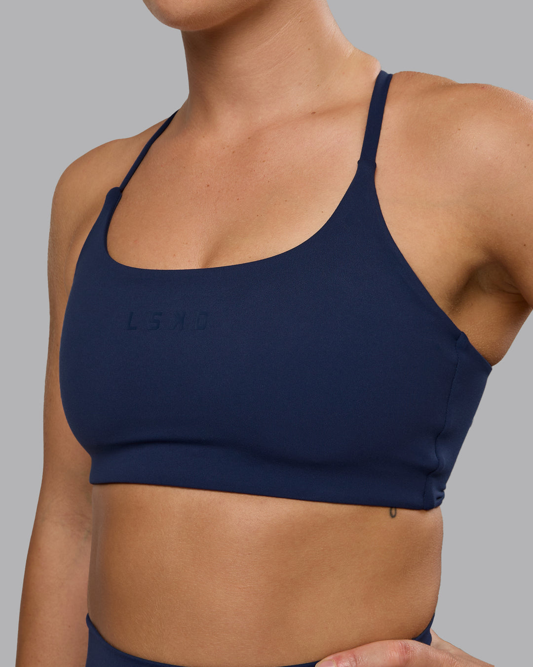 Woman wearing Twist Sports Bra - Future Navy | Model:Lyss | Size:S