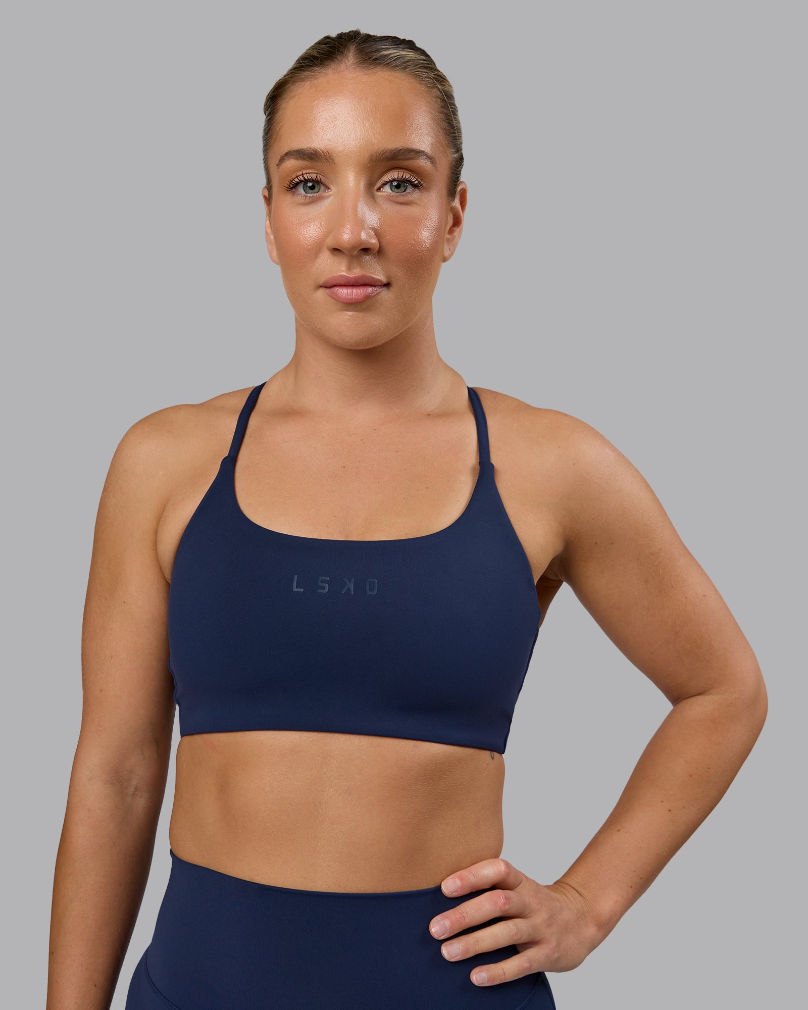 Woman wearing Twist Sports Bra - Future Navy | Model:Lyss | Size:S