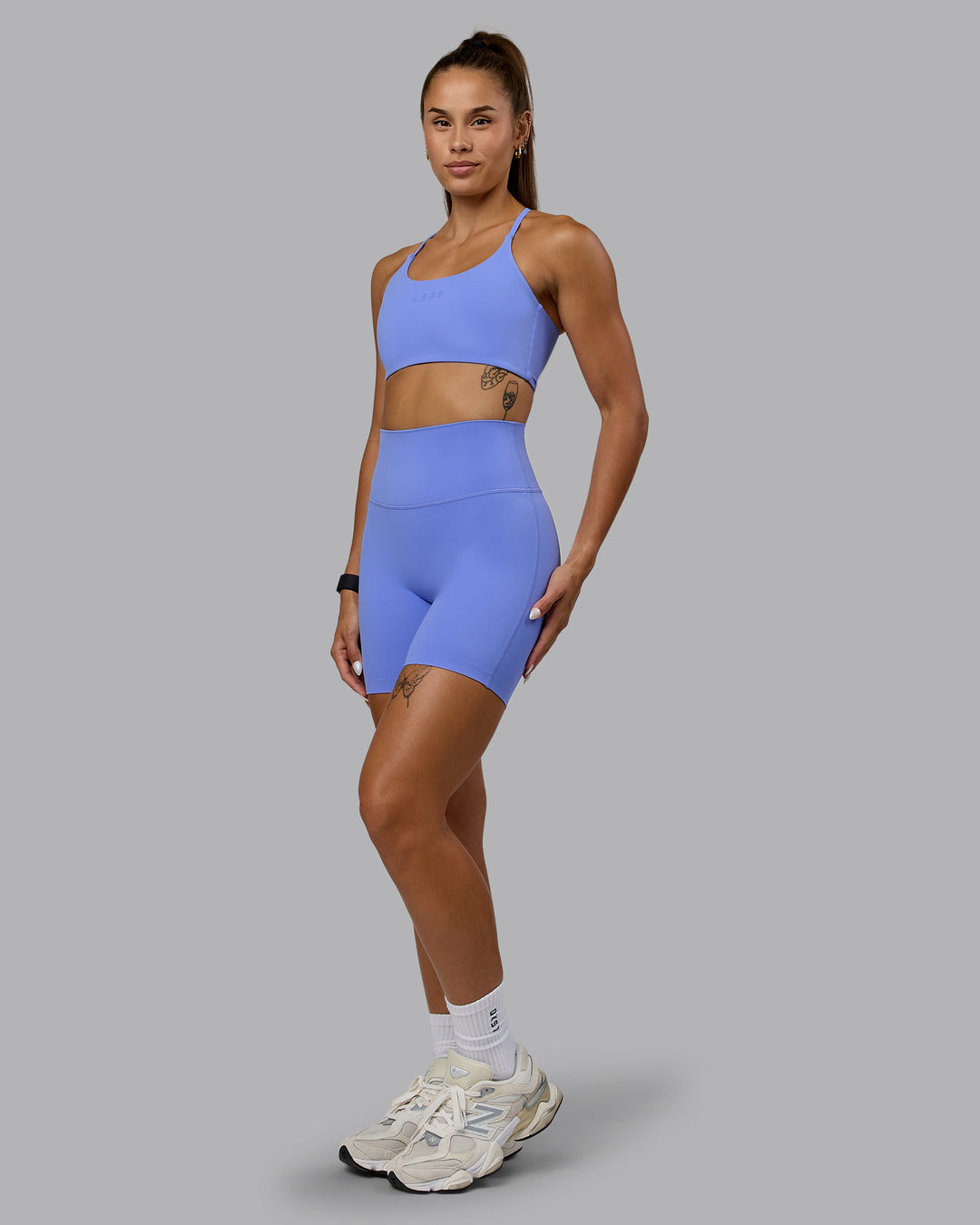 Woman wearing Twist Sports Bra - Indulgent Blue