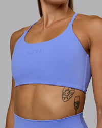Woman wearing Twist Sports Bra - Indulgent Blue