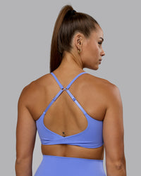 Woman wearing Twist Sports Bra - Indulgent Blue