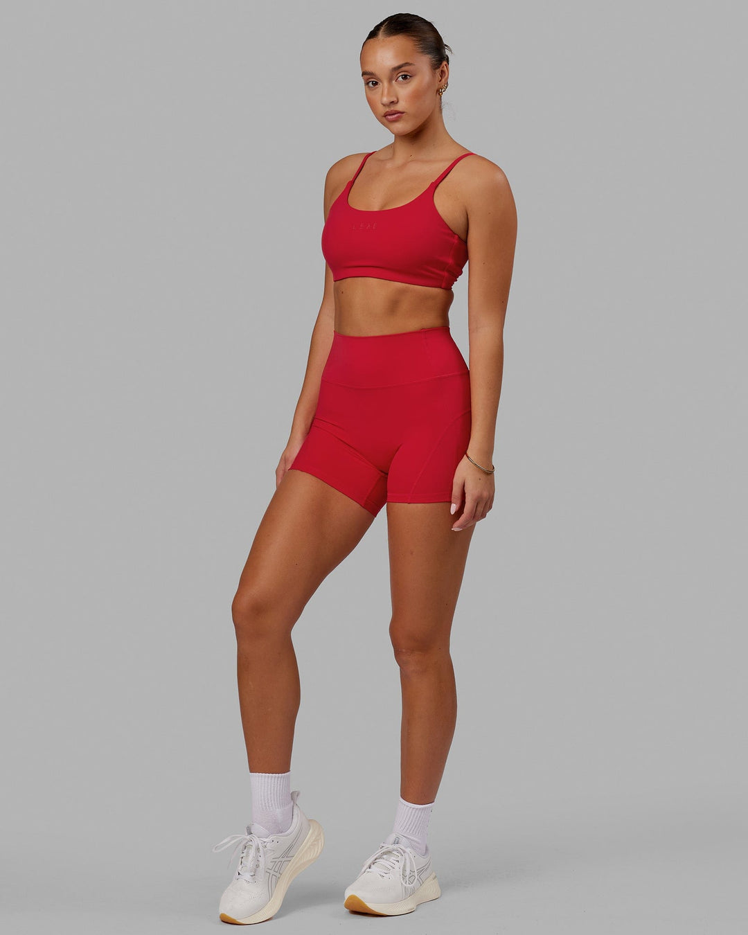 Woman wearing Twist Sports Bra - Scarlet