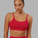 Woman wearing Twist Sports Bra - Scarlet