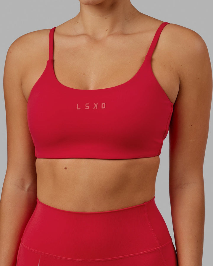 Woman wearing Twist Sports Bra - Scarlet