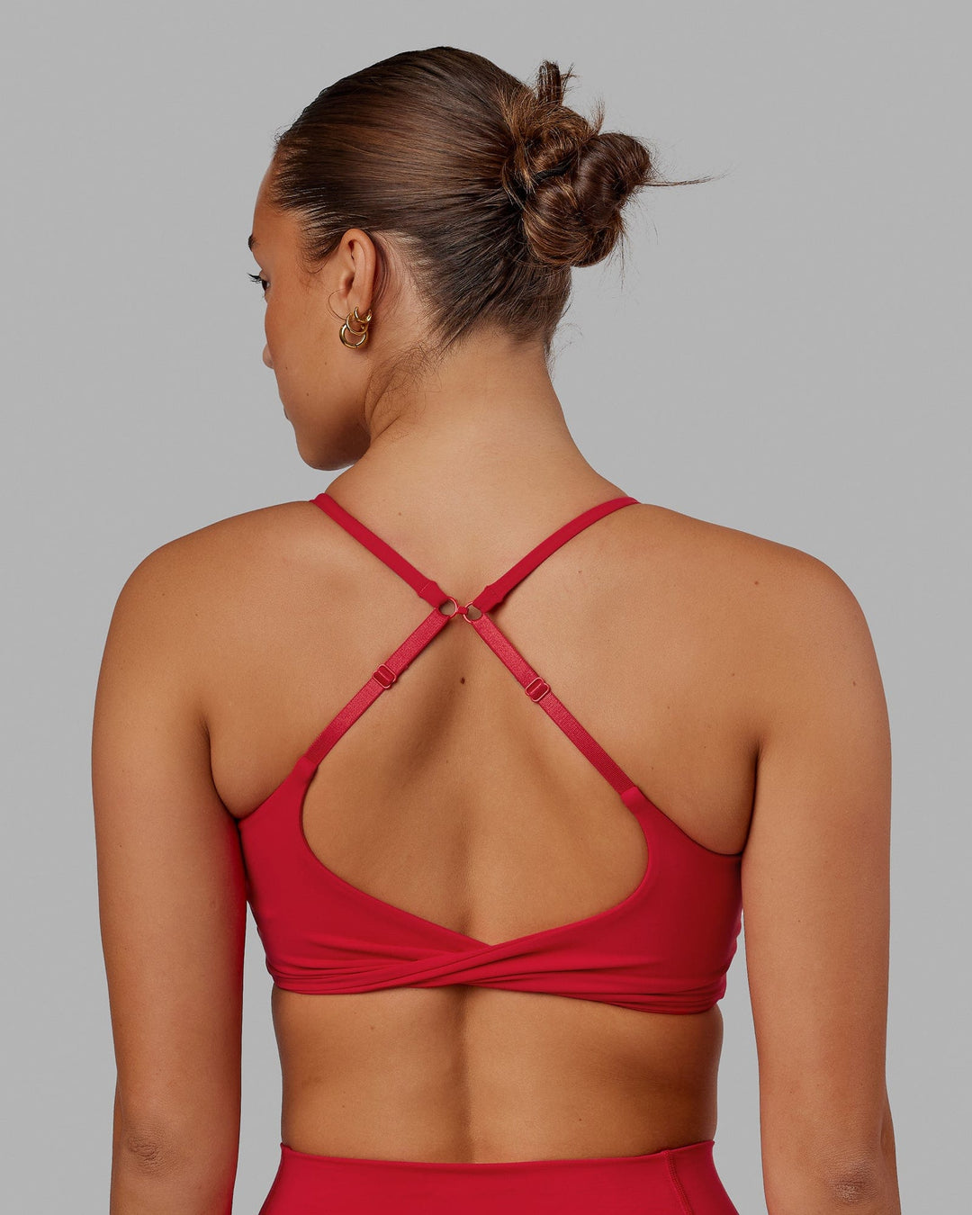 Woman wearing Twist Sports Bra - Scarlet