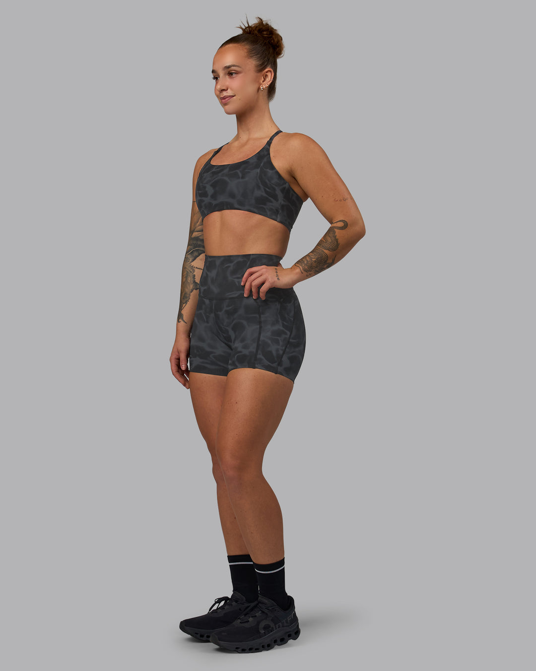 Woman wearing Twist Sports Bra - Tranquil-Black