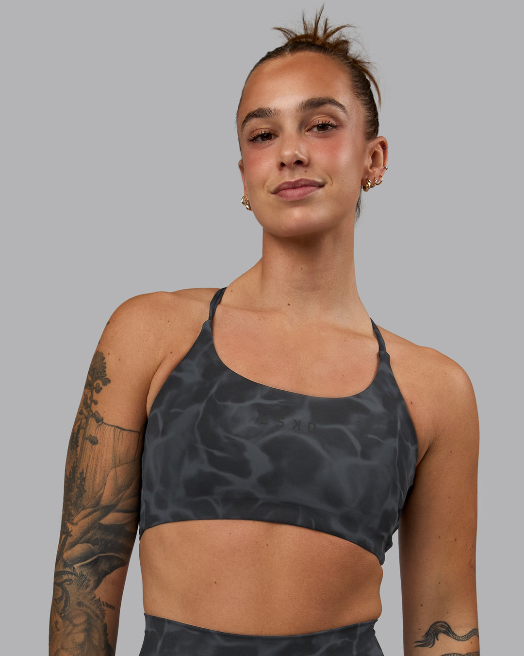 Woman wearing Twist Sports Bra - Tranquil-Black