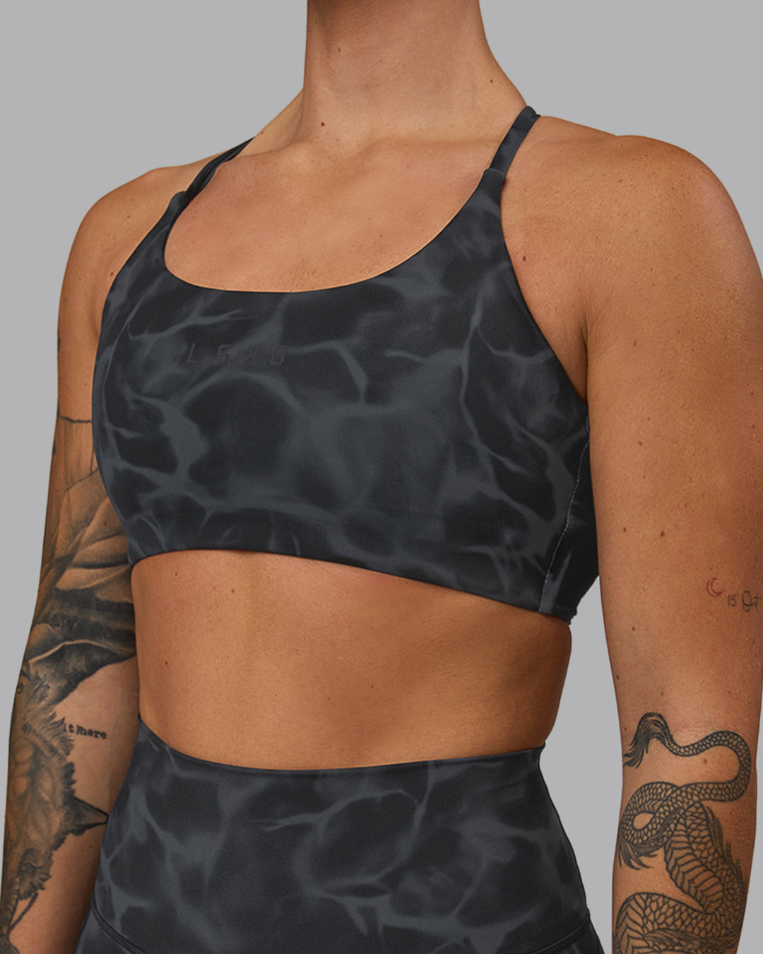 Woman wearing Twist Sports Bra - Tranquil-Black