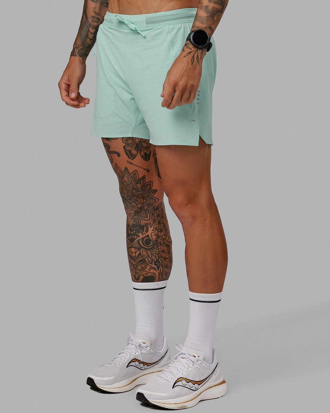 Man wearing UltraAir 5&quot; Lined Performance Short - Pastel Turquoise-Reflective