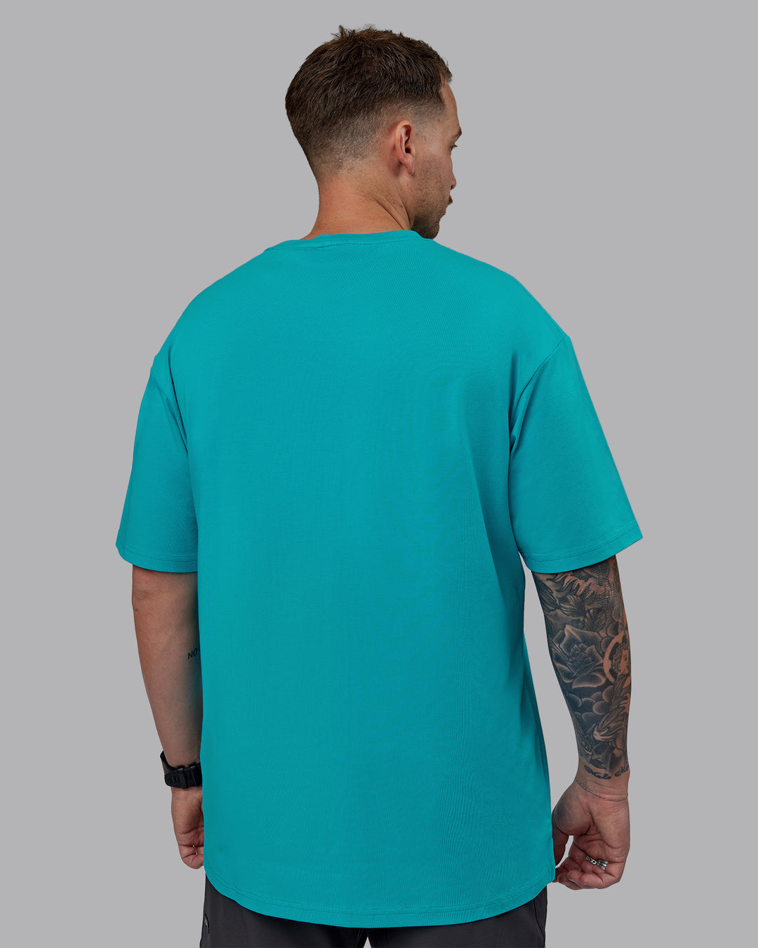 Man wearing Unisex 1% Better FLXCotton Tee Oversize - Blue Bird-White