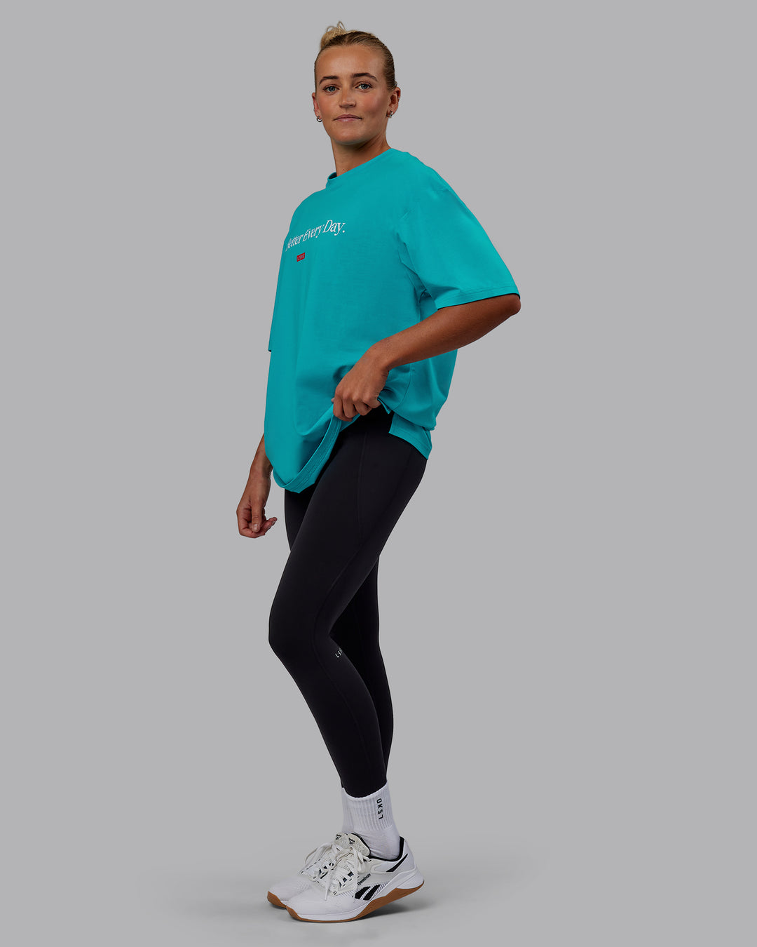 Woman wearing Unisex 1% Better FLXCotton Tee Oversize - Blue Bird-White