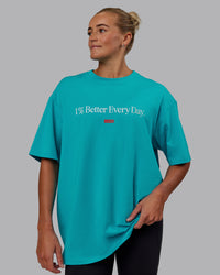 Woman wearing Unisex 1% Better FLXCotton Tee Oversize - Blue Bird-White