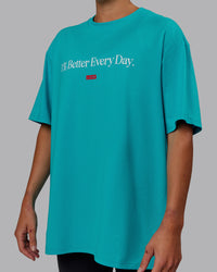 Woman wearing Unisex 1% Better FLXCotton Tee Oversize - Blue Bird-White