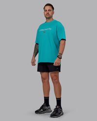 Man wearing Unisex 1% Better FLXCotton Tee Oversize - Blue Bird-White