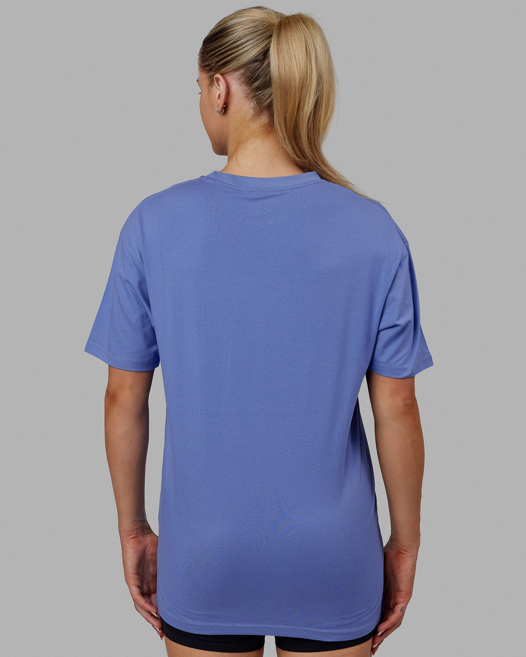 Woman wearing Unisex 1% Better FLXCotton Tee Oversize - Cornflower Blue