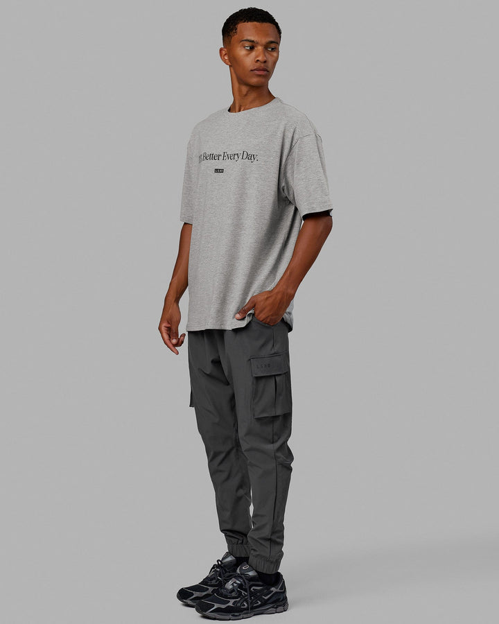 Man  wearing Unisex 1% Better FLXCotton Tee Oversize - Lt Grey Marl-Black