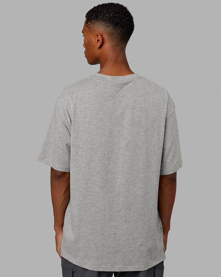 Man  wearing Unisex 1% Better FLXCotton Tee Oversize - Lt Grey Marl-Black