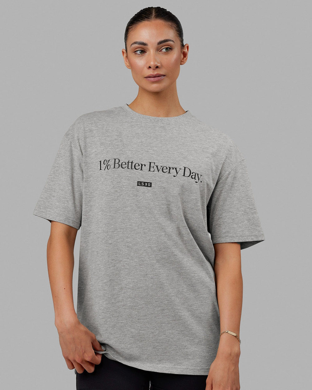 Woman  wearing Unisex 1% Better FLXCotton Tee Oversize - Lt Grey Marl-Black