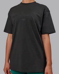 Woman wearing Unisex 1% Better FLXCotton Tee Oversize - Pirate Black-Black