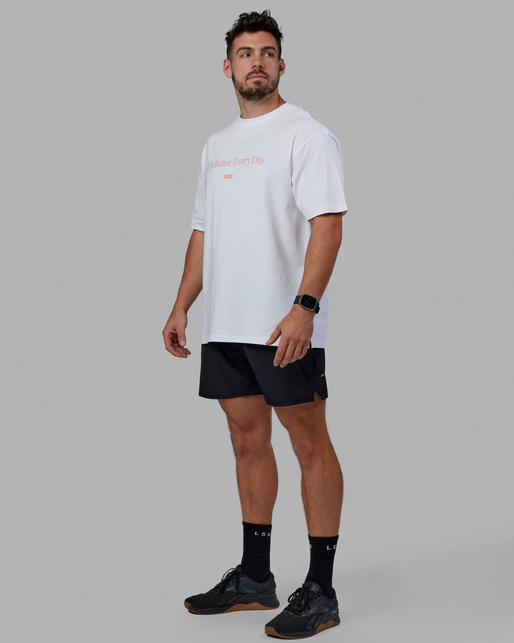 Man wearing Unisex 1% Better FLXCotton Tee Oversize - White-Coral