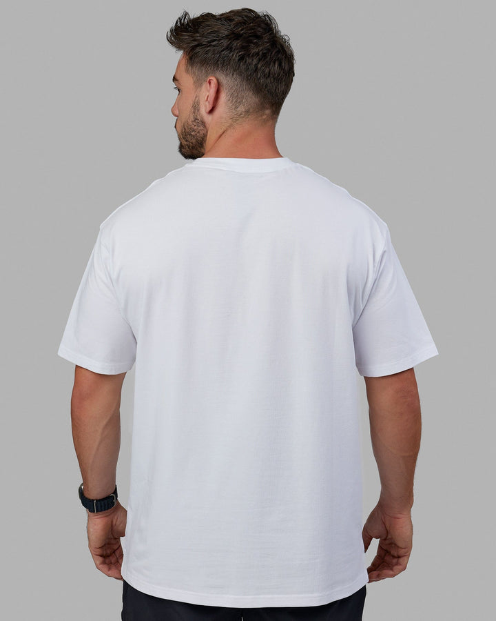 Man wearing Unisex 1% Better FLXCotton Tee Oversize - White-Coral