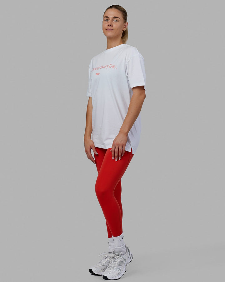 Woman wearing Unisex 1% Better FLXCotton Tee Oversize - White-Coral