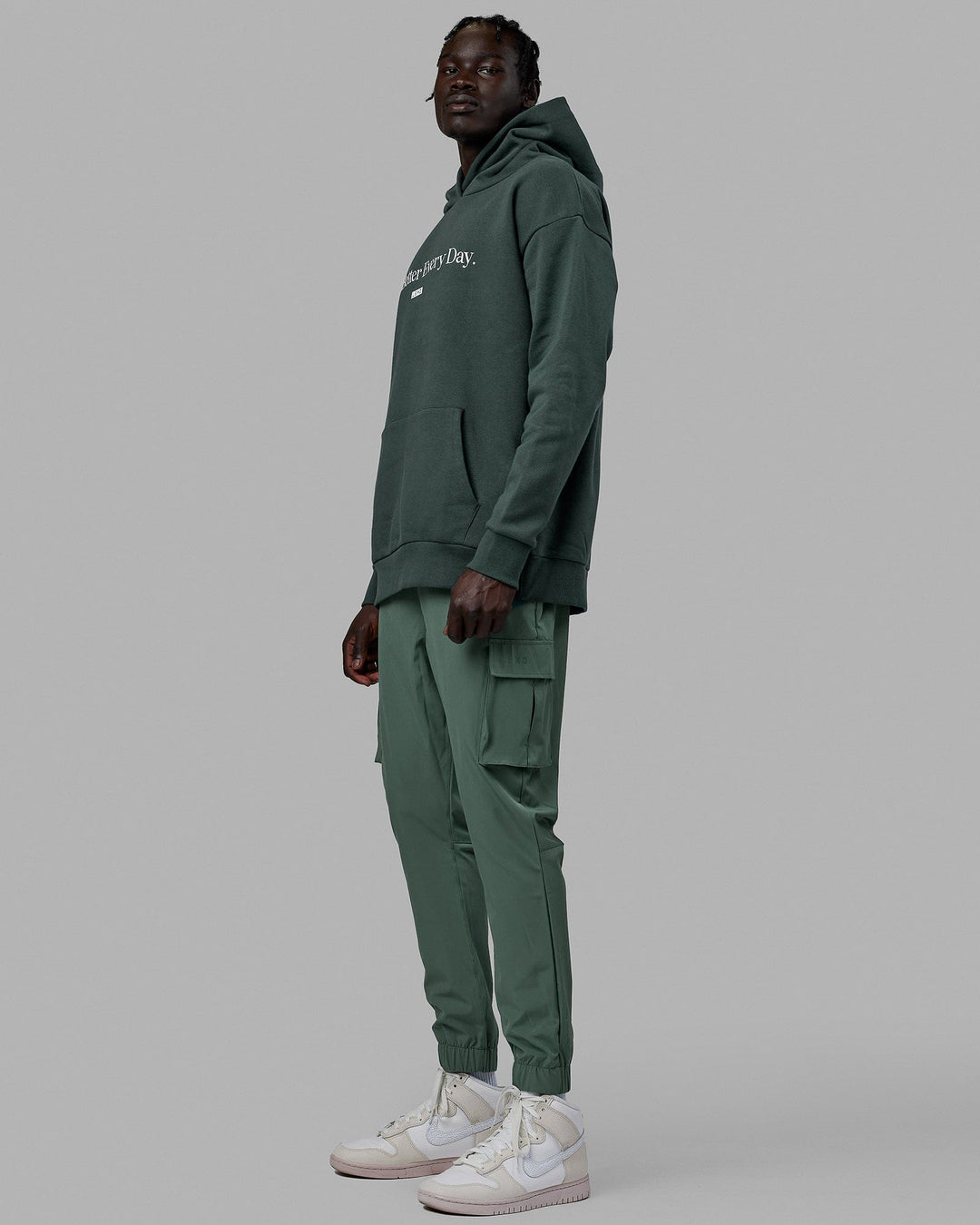 Man wearing Unisex 1% Better Hoodie Oversize - Vital Green