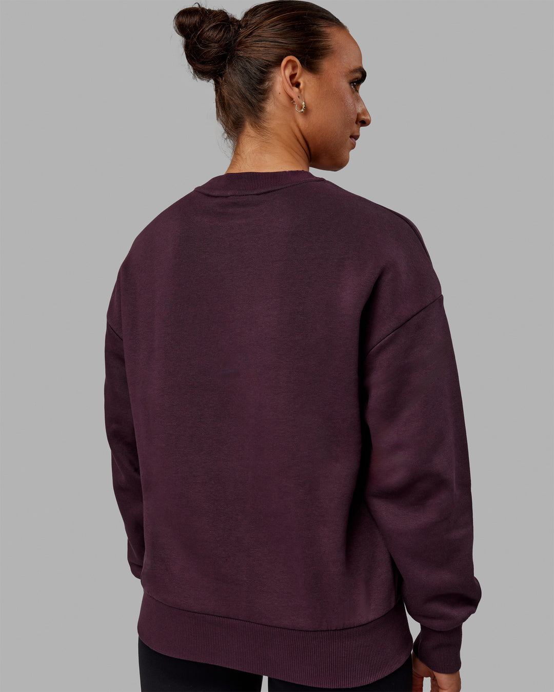 Woman wearing Unisex 1% Better Sweater Oversize - Midnight Plum