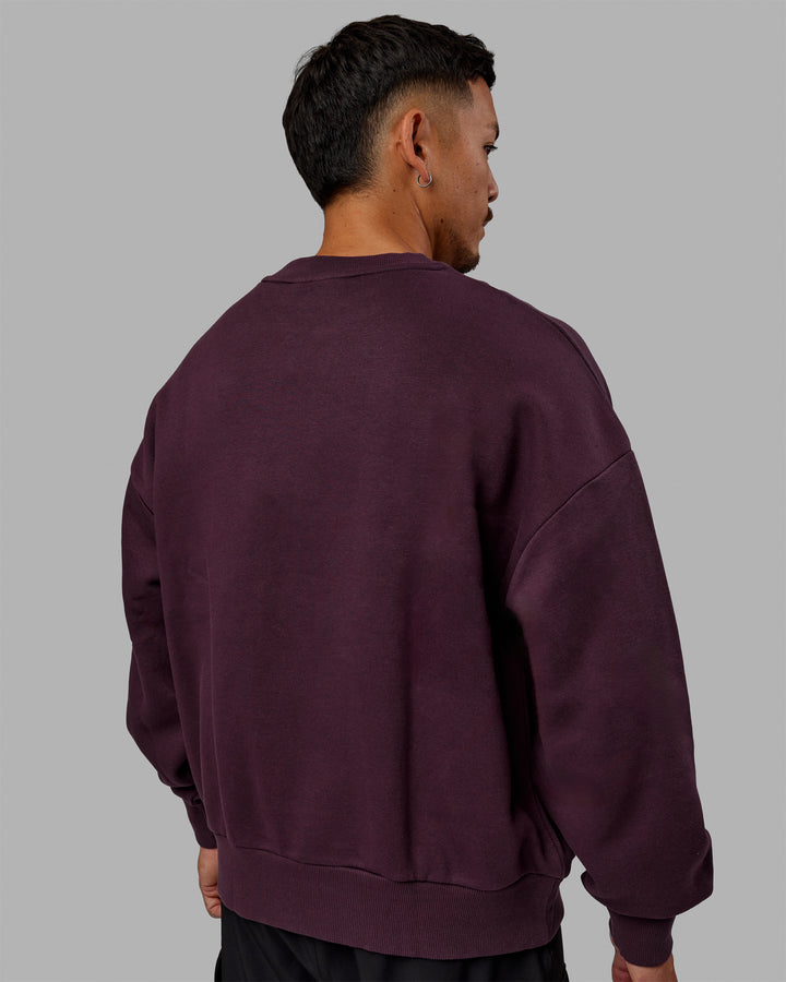 Man wearing Unisex 1% Better Sweater Oversize - Midnight Plum