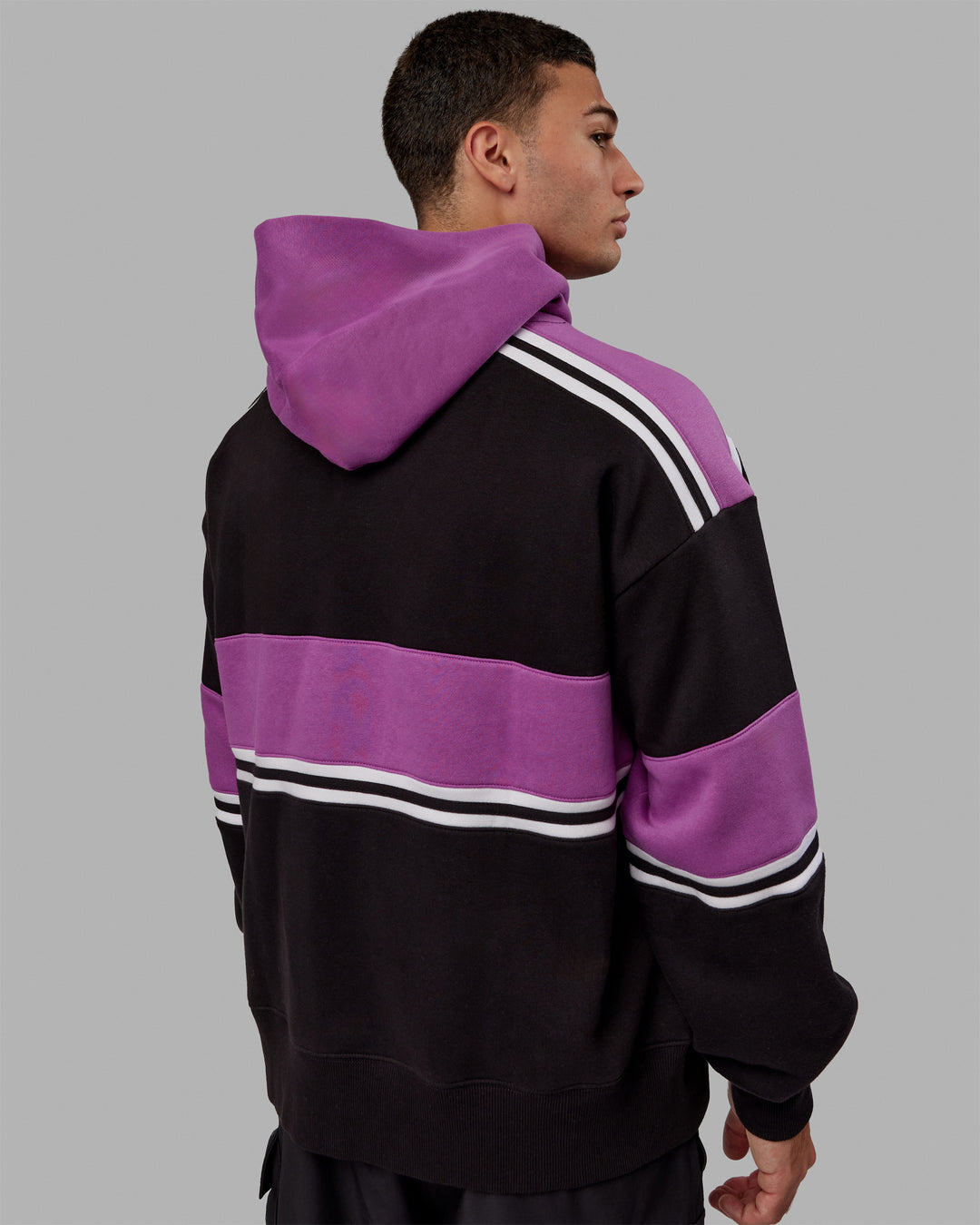 Man wearing Unisex A-Team Hoodie Oversize - Black-Hyper Violet