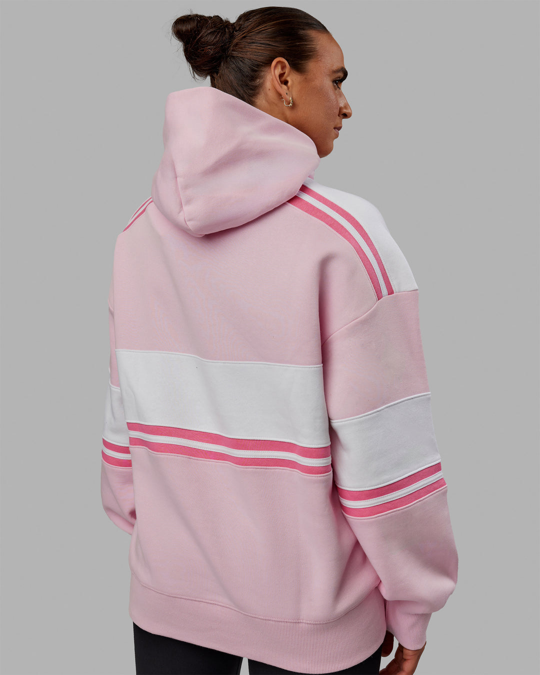 Woman wearing Unisex A-Team Hoodie Oversize - Petal Pink-White