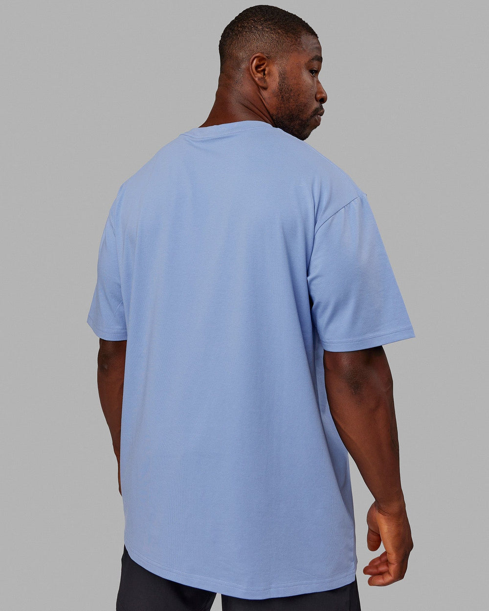 Man wearing Unisex Better Every Day FLXCotton Tee Oversize - Arctic Blue-Ultra Pink