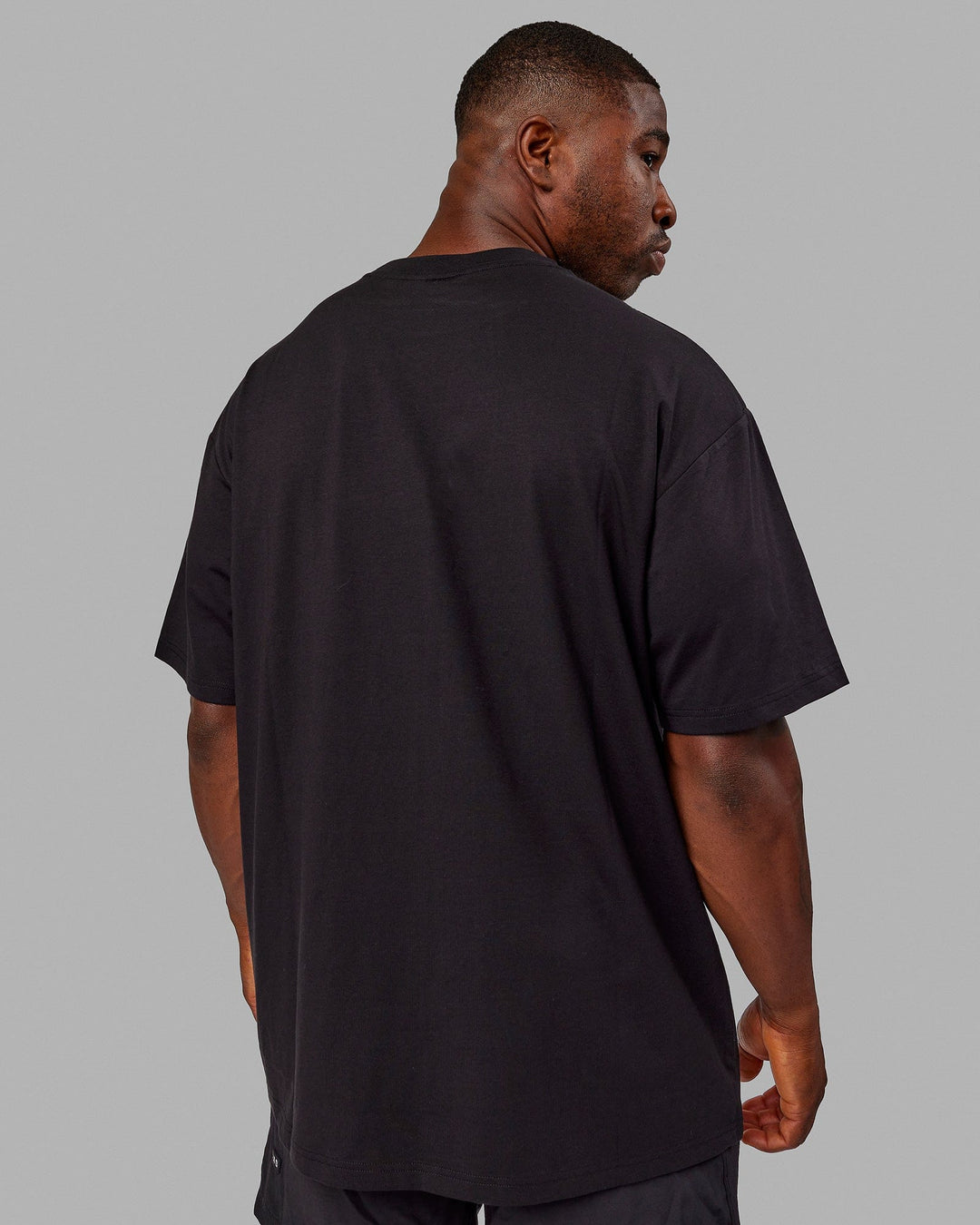Man wearing Unisex Better Every Day FLXCotton Tee Oversize - Black-Ultimate Grey