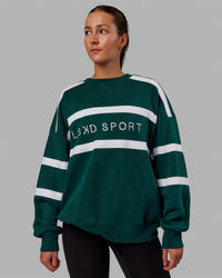 Woman wearing Unisex Collateral Sweater Oversize - Dark Moss-White