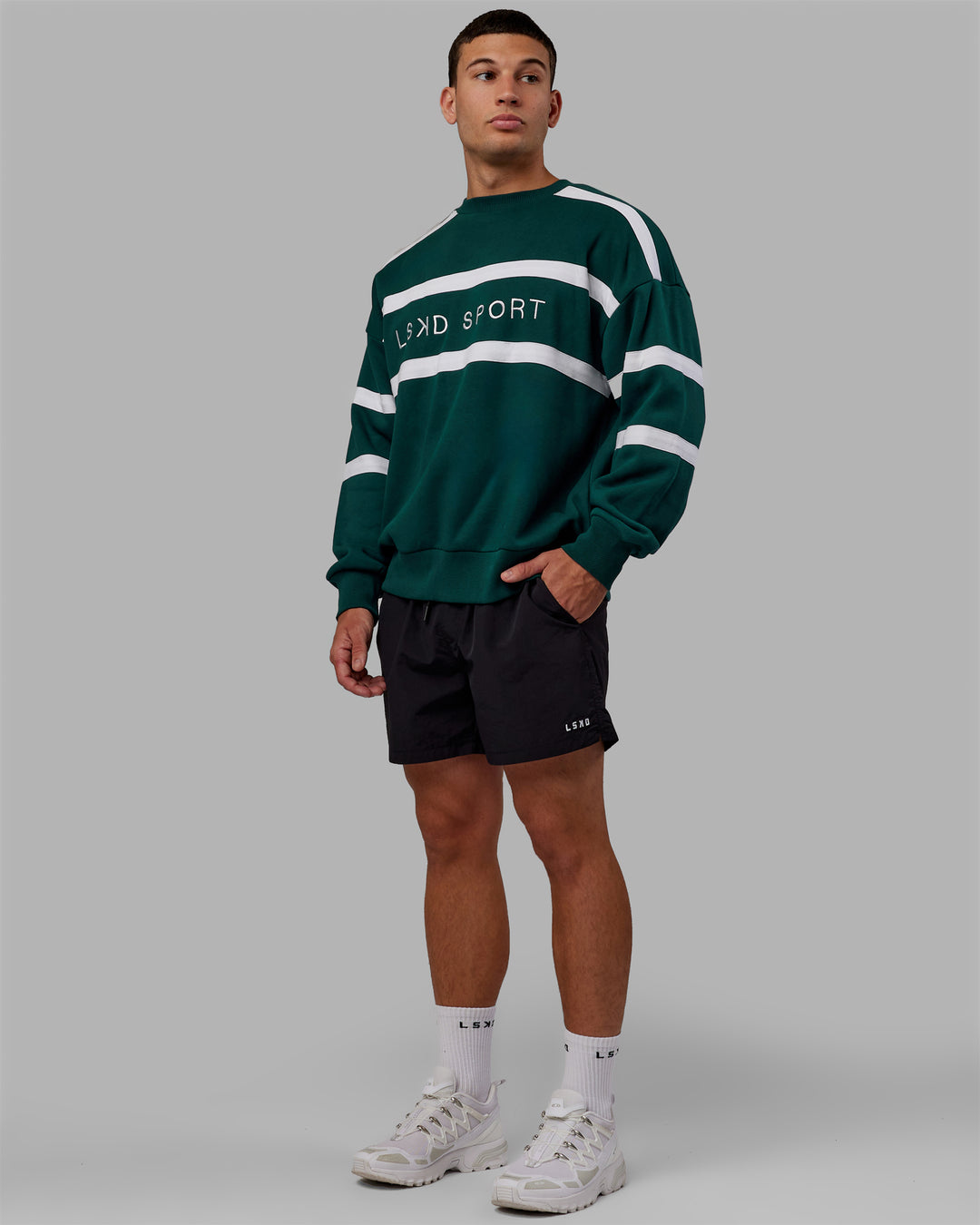 Man wearing Unisex Collateral Sweater Oversize - Dark Moss-White