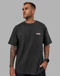 Man wearing Unisex E.T.J FLXCotton Tee Oversize - Pirate Black-Pop Pink