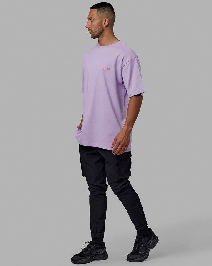 Man wearing Unisex Endeavour Heavyweight Tee Oversize - Pale Lilac-Impact Orange