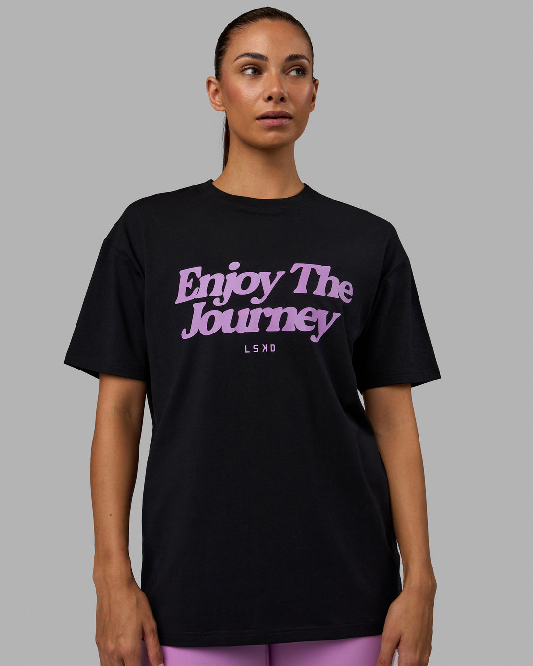 Woman wearing Unisex Enjoy The Journey FLXCotton Tee Oversize - Black-Light Violet
