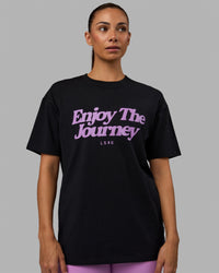 Woman wearing Unisex Enjoy The Journey FLXCotton Tee Oversize - Black-Light Violet